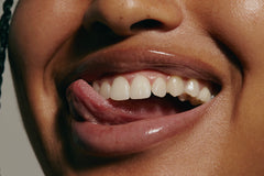 model smiling, wearing peptide lip treatment (close up)