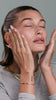 Hailey Bieber applying skincare on face