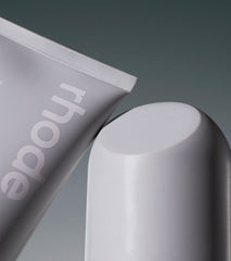left: corner of barrier restore cream tube; right: top of peptide glazing fluid bottle (cap)