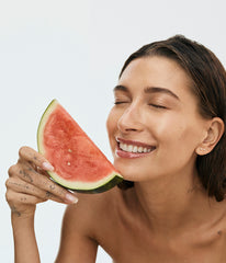 hailey bieber with watermelon, wearing peptide lip treatment (watermelon slice)