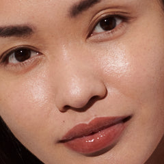 Model wears Peptide Lip Tint in shade Toast