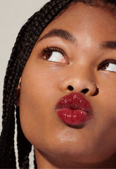 Model with glossy, tinted lips - wearing Raspberry Jelly Lip Tint