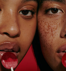 models wearing peptide lip treatment, with lollipops