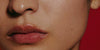 model wearing peptide lip treatment (watermelon slice) - close up