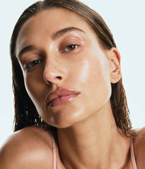 Hailey Bieber with glossy lips, wearing rhode peptide lip treatment