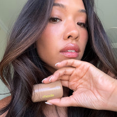 creator holding pocket blush in tan line
