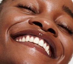 model wearing peptide lip tint in espresso