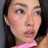 model wearing peptidel ip tint in jelly bean