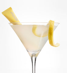 Martini glass with a lemon twist and a peptide lip tint lemontini