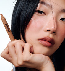 model wearing peptide lip tint salty tan