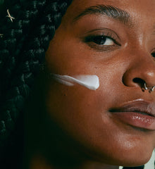 model with barrier restore cream swatch on cheek