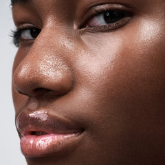 close up of model's face, wearing peptide lip tint in jelly bean