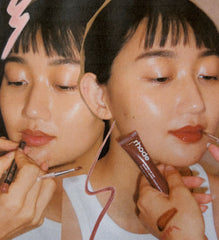 Model wears Peptide Lip Tint in shade Espresso