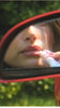 Hailey Bieber with glossy lips, applying peptide lip treatment in strawberry glaze