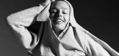 Model in a cozy sweatshirt with a dark background
