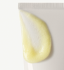 Corner of Pineapple Refresh Cleanser bottle with a swatch