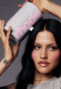 model holding the rhode peptide lip set box