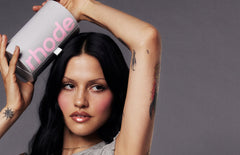 model holding the rhode peptide lip set box