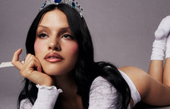 model with glossy lips, holding peptide lip treatment