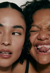 2 models with glossy lips, both wearing peptide lip treatment on lips