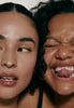 2 models with glossy lips, both wearing peptide lip treatment on lips
