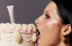 model biting into a vanilla cake