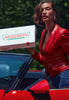 Hailey Bieber with glossy lips, holding a box of Krispy Kreme Doughnuts