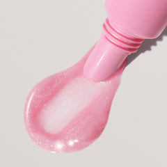 a close up of peptide lip tint in jelly bean, with formula squeezing out of tube