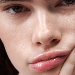 close up of model's face, with peptide lip tint in jelly bean on lips