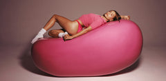 Hailey Bieber laying on top of a jumbo jelly bean
