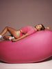 Hailey Bieber laying on top of a jumbo jelly bean