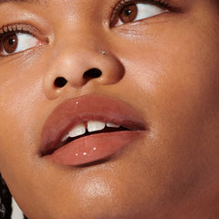 Model wears Peptide Lip Tint in shade Toast