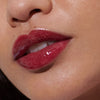 Model wears Peptide Lip Tint in shade Raspberry Jelly