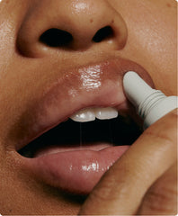 model applying peptide lip treatment on lips