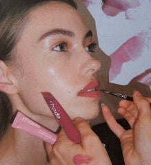 Model wears Peptide Lip Tint in shade Raspberry Jelly