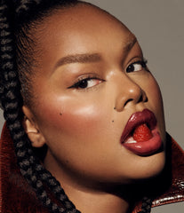 Model wears Peptide Lip Tint in shade Raspberry Jelly