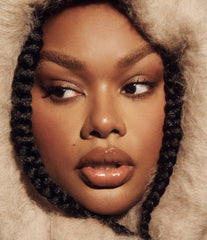 Model wears Peptide Lip Tint in shade Toast