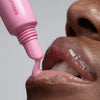close up of model's lips, applying peptide lip tint in jelly bean