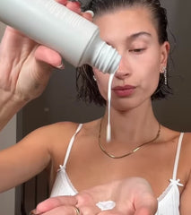 Hailey Bieber pouring Glazing Milk into palm of her hands