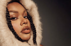 Model wears Peptide Lip Tint in shade Toast
