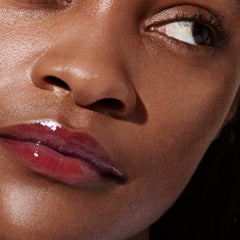 Model wears Peptide Lip Tint in shade Raspberry Jelly