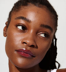 model with glossy lips, wearing raspberry jelly lip tint