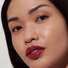 model with glossy lips, wearing raspberry jelly lip tint