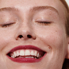 model with glossy lips, wearing raspberry jelly lip tint
