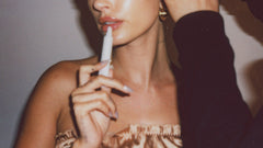 Hailey Bieber applying peptide lip treatment on lips