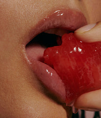 mouth close up, wearing peptide lip treatment, biting watermelon