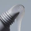 close up of peptide lip treatment applicator with formula dripping down