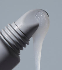 close up of peptide lip treatment applicator with formula dripping down
