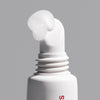 close up of the peptide lip treatment applicator, with formula squeezing out