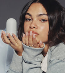 Ariana Greenblatt with glazed skin holding the peptide glazing fluid